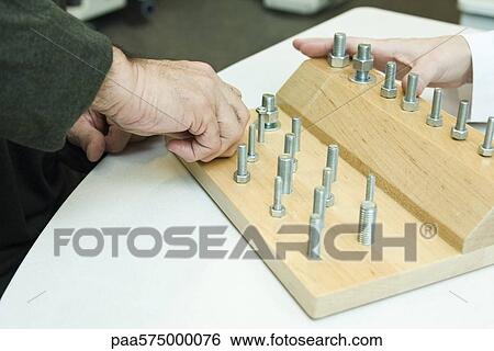 Using therapeutic tool for improving fine motor and sensory function View Large Photo Image Stock Photograph - Using therapeutic tool for improving fine motor and sensory function. Fotosearch