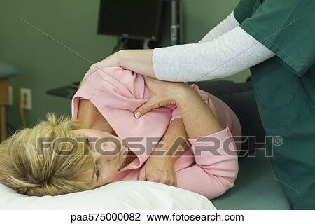 Woman being treated by physical therapist View Large Photo Image Stock Image - Woman being treated by physical therapist. Fotosearch