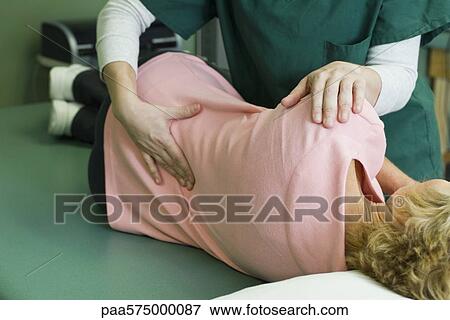 Woman being treated by physical therapist View Large Photo Image Stock Photo - Woman being treated by physical therapist. Fotosearch