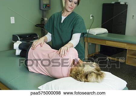 Woman being treated by physical therapist View Large Photo Image Stock Photo - Woman being treated by physical therapist. Fotosearch