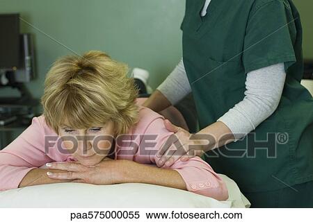 Woman enjoying massage by physical therapist View Large Photo Image Stock Photography - Woman enjoying massage by physical therapist. Fotosearch