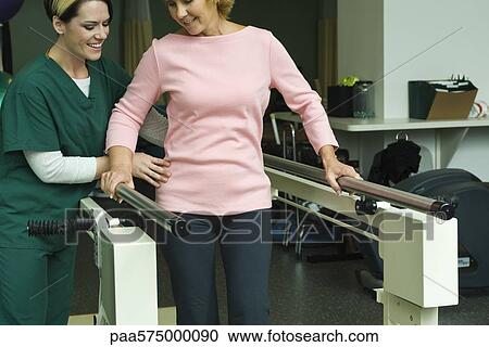 Woman undergoing post-surgery rehabilitation exercises to regain ability to walk View Large Photo Image Stock Image - Woman undergoing post-surgery rehabilitation exercises to regain ability to walk. Fotosearch