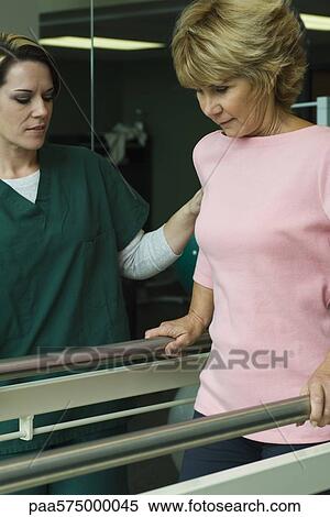 Woman undergoing post-surgery rehabilitation exercises to regain ability to walk View Large Photo Image Stock Photography - Woman undergoing post-surgery rehabilitation exercises to regain ability to walk. Fotosearch