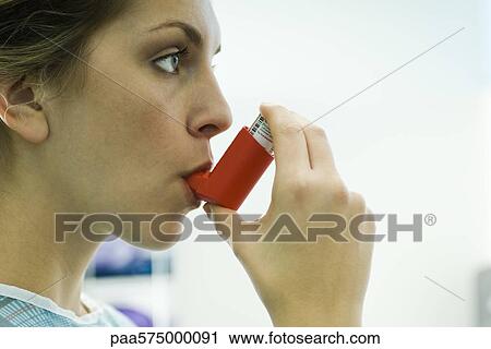 Woman using asthma inhaler View Large Photo Image Stock Image - Woman using asthma inhaler. Fotosearch