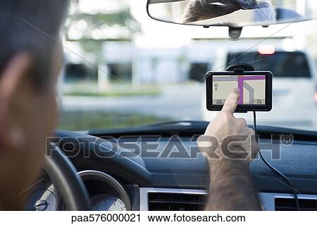 Driver using GPS for navigational assistance View Large Photo Image Stock Image - Driver using GPS for navigational assistance. Fotosearch