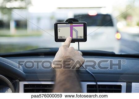 Driver using GPS unit View Large Photo Image Stock Photo - Driver using GPS unit. Fotosearch