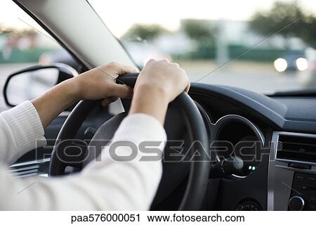Driving car with both hands on the steering wheel View Large Photo Image Stock Image - Driving car with both hands on the steering wheel. Fotosearch