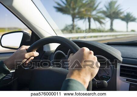 Driving with both hands on steering wheel View Large Photo Image Stock Image - Driving with both hands on steering wheel. Fotosearch