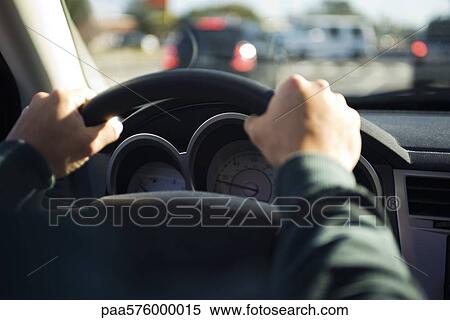 Driving with both hands on the steering wheel View Large Photo Image Stock Photography - Driving with both hands on the steering wheel. Fotosearch