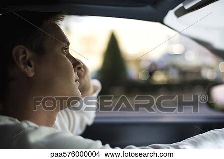 Man driving, lost in thought View Large Photo Image Picture - Man driving, lost in thought. Fotosearch