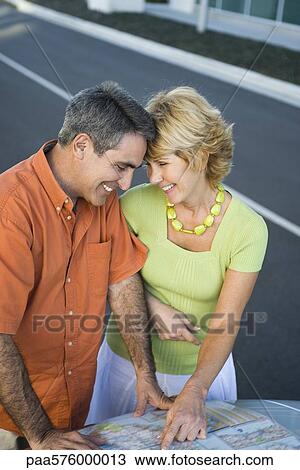 Mature couple looking at road map together planning route for road trip View Large Photo Image Stock Image - Mature couple looking at road map together planning route for road trip. Fotosearch