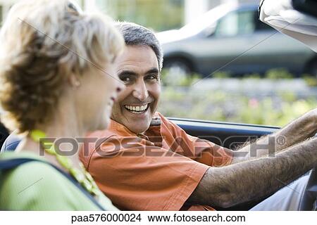 Mature couple out for drive together, man smiling at wife View Large Photo Image Picture - Mature couple out for drive together, man smiling at wife. Fotosearch