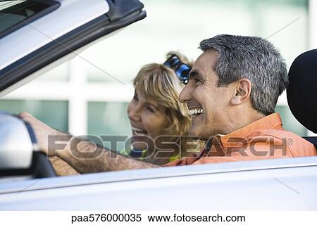 Mature couple out for pleasure drive View Large Photo Image Stock Photography - Mature couple out for pleasure drive. Fotosearch