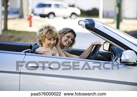 Mature woman out for drive with daughter in convertible View Large Photo Image Stock Image - Mature woman out for drive with daughter in convertible. Fotosearch