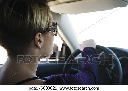 Woman driving, concentrating on road ahead View Large Photo Image Stock Photography - Woman driving, concentrating on road ahead. Fotosearch