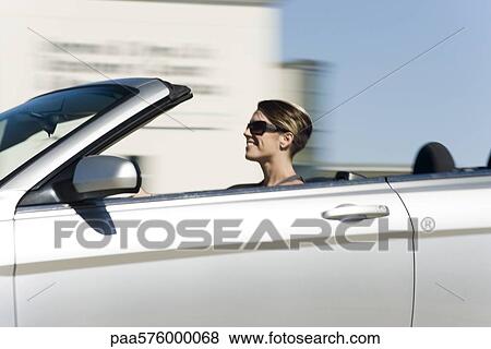 Woman driving fast in convertible View Large Photo Image Stock Photo - Woman driving fast in convertible. Fotosearch