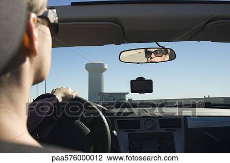 Woman driving, reflection in rearview mirror View Large Photo Image Stock Image - Woman driving, reflection in rearview mirror. Fotosearch