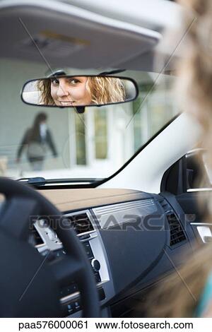 Woman driving, reflection in rearview mirror View Large Photo Image Stock Image - Woman driving, reflection in rearview mirror. Fotosearch