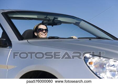Woman enjoying pleasure drive on sunny day View Large Photo Image Stock Image - Woman enjoying pleasure drive on sunny day. Fotosearch