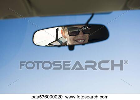 Woman's face reflected in rearview mirror View Large Photo Image Stock Image - Woman's face reflected in rearview mirror. Fotosearch