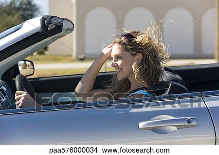 Young woman driving convertible View Large Photo Image Picture - Young woman driving convertible. Fotosearch