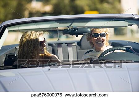 Young woman enjoying outing in car with mother View Large Photo Image Stock Photograph - Young woman enjoying outing in car with mother. Fotosearch
