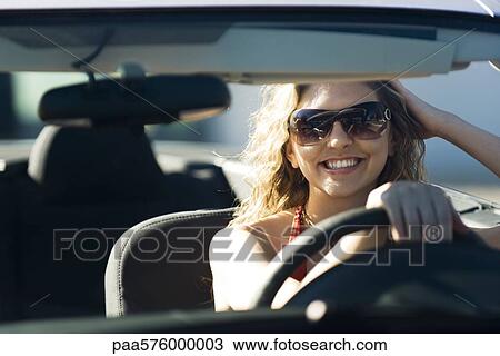 Young woman out for drive on sunny day View Large Photo Image Stock Image - Young woman out for drive on sunny day. Fotosearch