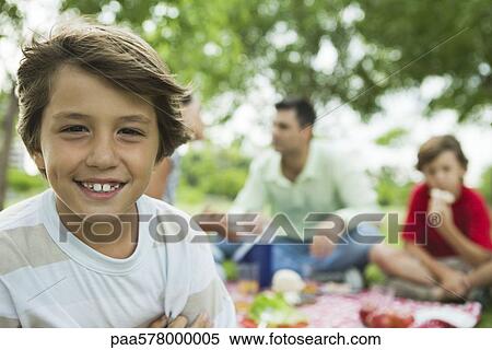 Boy having picnic with family, portrait View Large Photo Image Stock Photography - Boy having picnic with family, portrait. Fotosearch