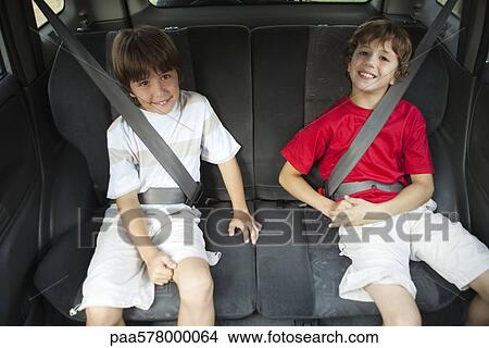 Brothers sitting in car, portrait View Large Photo Image Picture - Brothers sitting in car, portrait. Fotosearch