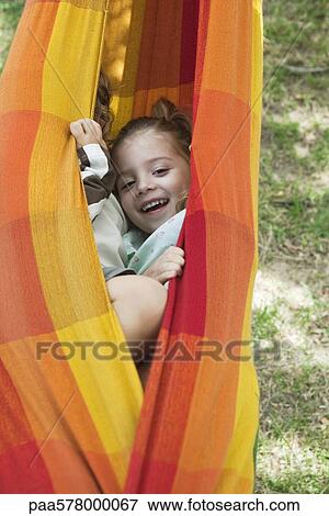 Stock Photo - Children hiding together in hammock. Fotosearch
