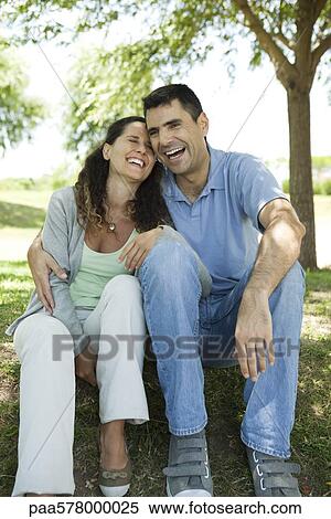 Couple laughing together outdoors View Large Photo Image Stock Photography - Couple laughing together outdoors. Fotosearch