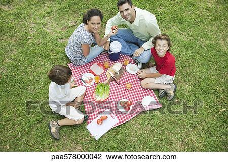 Family enjoying picnic outdoors View Large Photo Image Stock Image - Family enjoying picnic outdoors. Fotosearch