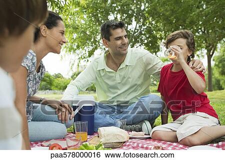 Family enjoying picnic outdoors View Large Photo Image Stock Photograph - Family enjoying picnic outdoors. Fotosearch