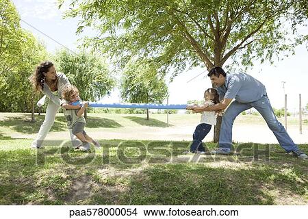 Family playing tug-of-war in park View Large Photo Image Picture - Family playing tug-of-war in park. Fotosearch