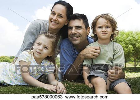 Family relaxing together outdoors, portrait View Large Photo Image Stock Image - Family relaxing together outdoors, portrait. Fotosearch