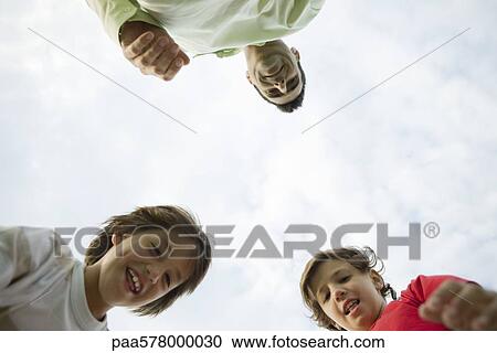 Father and sons outdoors, low angle view View Large Photo Image Stock Image - Father and sons outdoors, low angle view. Fotosearch