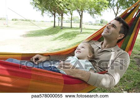 Father and young daughter relaxing together in hammock View Large Photo Image Stock Photography - Father and young daughter relaxing together in hammock. Fotosearch