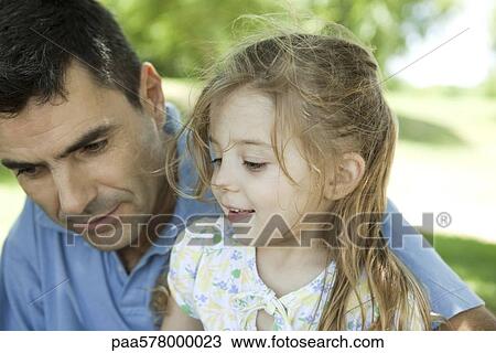 Father and young daughter talking outdoors View Large Photo Image Stock Image - Father and young daughter talking outdoors. Fotosearch