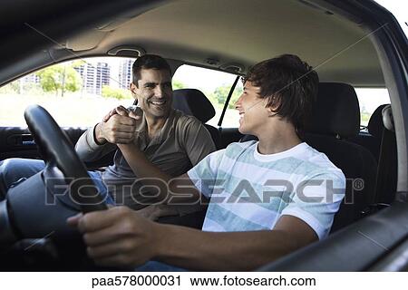 Father teaching his son to drive View Large Photo Image Stock Image - Father teaching his son to drive. Fotosearch