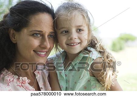 Mother and daughter together outdoors, portrait View Large Photo Image Stock Image - Mother and daughter together outdoors, portrait. Fotosearch