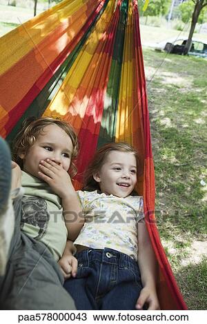 Young brother and sister lying in hammock together View Large Photo Image Stock Image - Young brother and sister lying in hammock together. Fotosearch