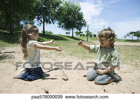 Stock Photo - Young children playing in sand at park. Fotosearch