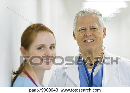 Doctor and nurse smiling, portrait View Large Photo Image Stock Image - Doctor and nurse smiling, portrait. Fotosearch