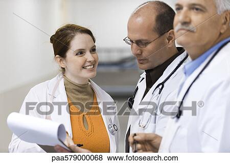 Doctor showing colleague medical chart View Large Photo Image Stock Photo - Doctor showing colleague medical chart. Fotosearch
