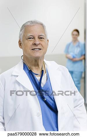 Stock Photo - Doctor smiling, portrait. Fotosearch