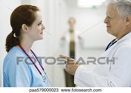 Doctor talking to nurse View Large Photo Image Stock Image - Doctor talking to nurse. Fotosearch