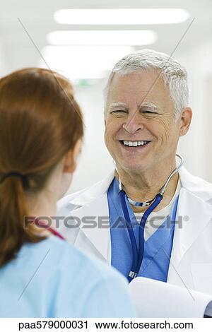 Doctor talking to nurse View Large Photo Image Stock Image - Doctor talking to nurse. Fotosearch