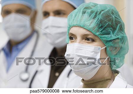 Doctors wearing surgical masks View Large Photo Image Stock Photo - Doctors wearing surgical masks. Fotosearch