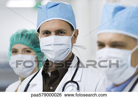 Stock Photograph - Doctors wearing surgical masks. Fotosearch