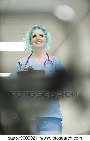 Nurse wearing surgical cap, low angle view View Large Photo Image Stock Image - Nurse wearing surgical cap, low angle view. Fotosearch